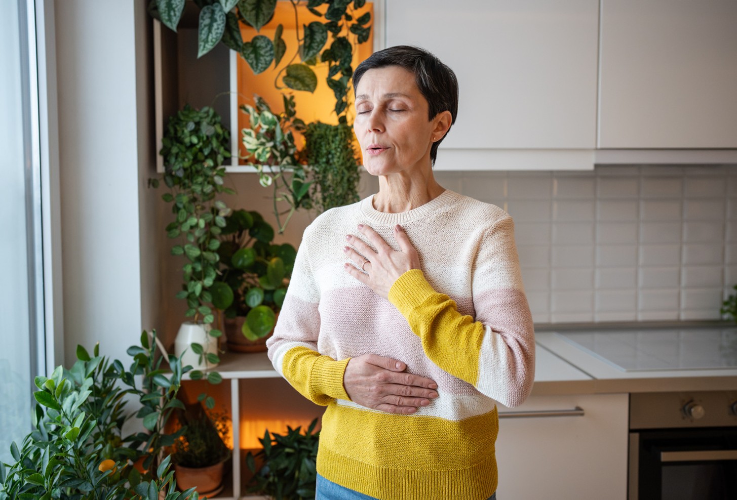 Woman standing breathing.